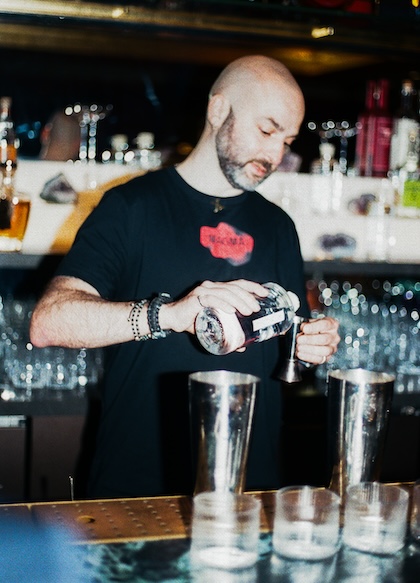 Irakli Agladze pouring a drink behind the MAGMA bar